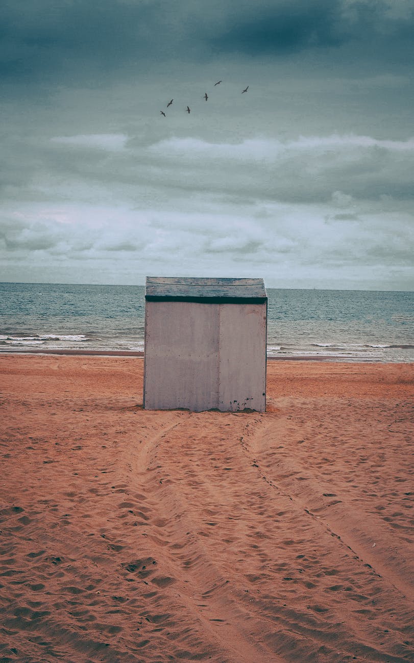 gray storage shed on brown sand